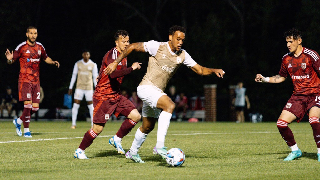 Birmingham Legion FC's AJ Paterson dribbles among a host of Chattanooga Red Wolves SC Players in a 2024 match. Legion FC and Red Wolves SC were drawn into Group 3 for the 2025 USL Jägermeister Cup.
